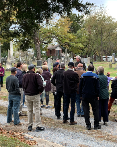 David Heiby leading a group on a private cemetery tour in Alexandria, VA, at the Wilkes Street Cemetery Complex, discussing the history of notable figures buried there.